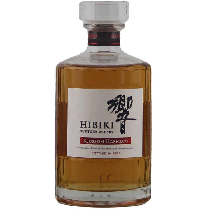 A bottle of Hibiki Blossom Harmony 2023 Japanese Blended Malt Whisky, limited edition, in clear glass with a white label featuring black and red text plus Japanese characters, highlights its amber whisky inside.