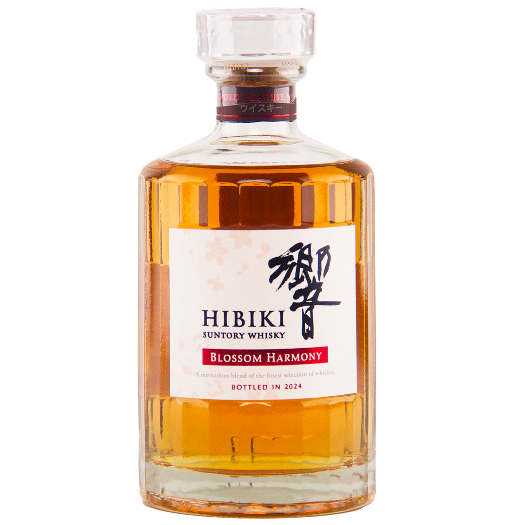 A bottle of Hibiki Blossom Harmony 2024 Limited Edition features amber whisky, a white label with black and red text plus Japanese characters, and a clear cap. Matured in sakura cask and bottled in 2024.