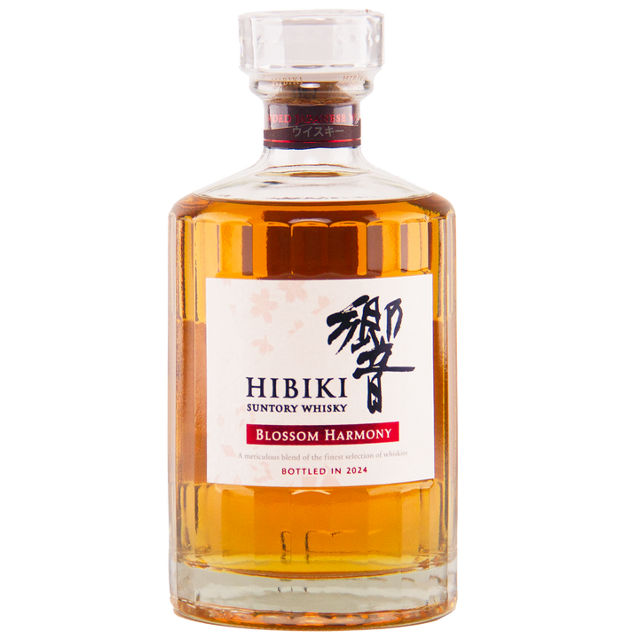 A bottle of Hibiki Blossom Harmony 2024 Limited Edition features amber whisky, a white label with black and red text plus Japanese characters, and a clear cap. Matured in sakura cask and bottled in 2024.