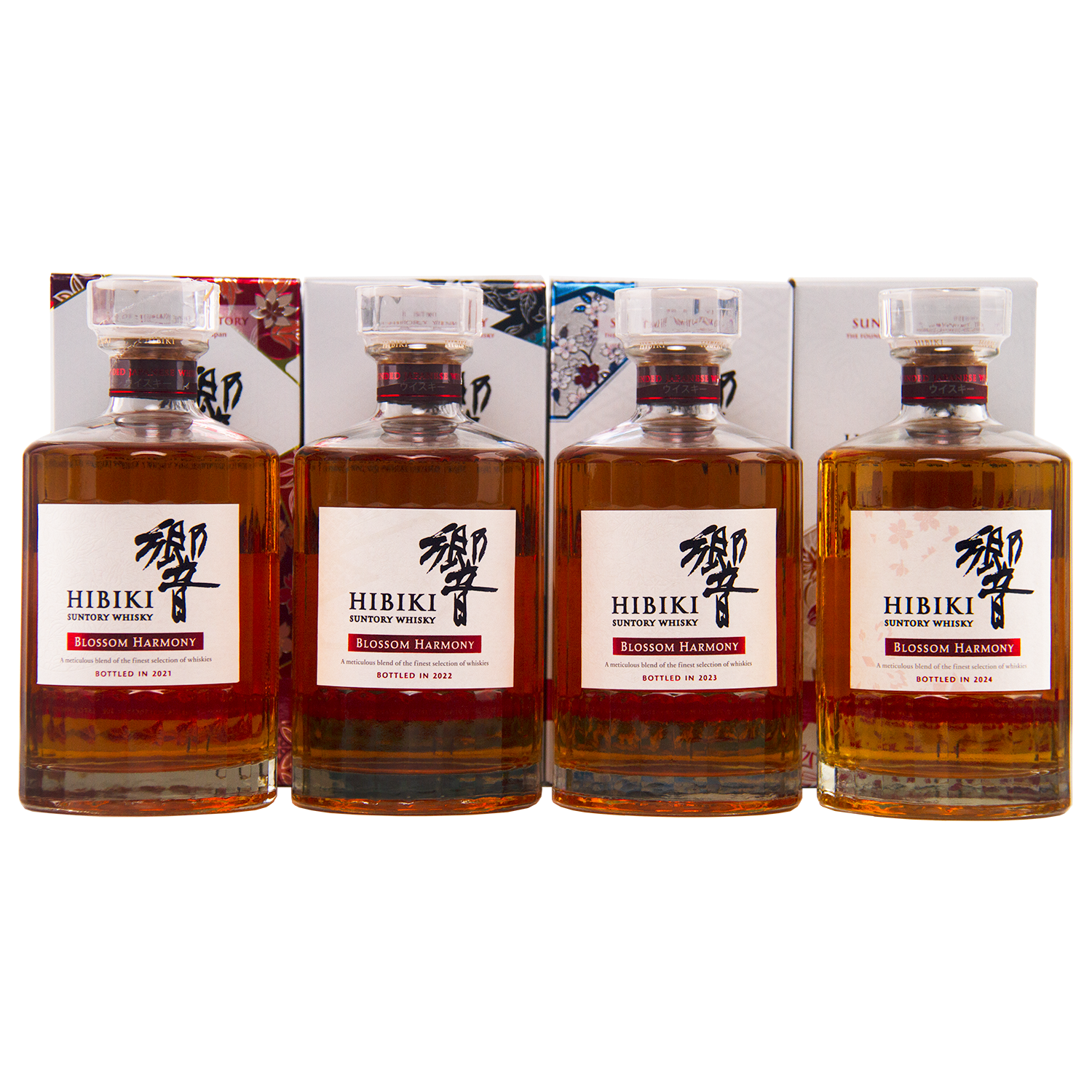 Four bottles from the Hibiki Blossom Harmony Limited Edition Collection 2021 to 2024 are displayed with their decorative boxes, each featuring a clear stopper and a striking white label—an exquisite Suntory release.