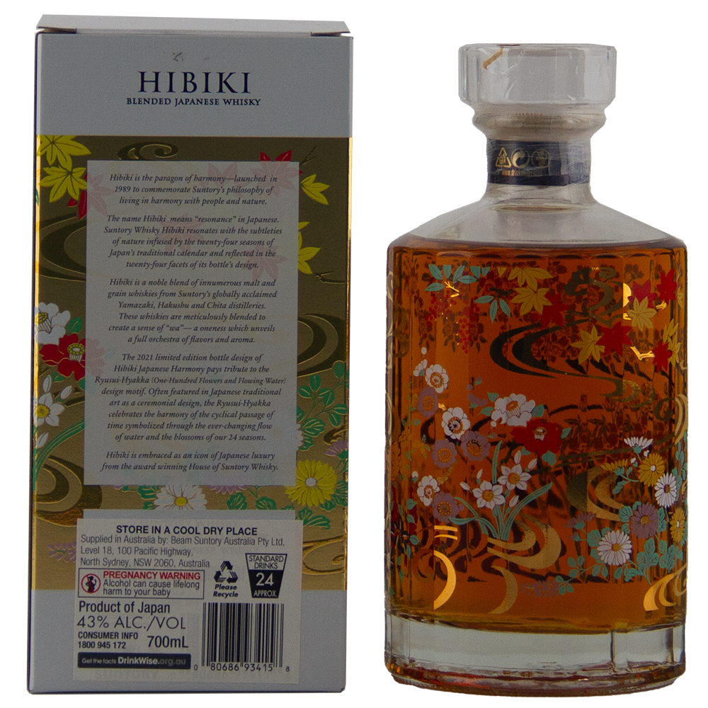 A decorative bottle and box of Hibiki Japanese Harmony Limited Edition 2021 stand upright side by side. The bottle showcases floral and gold patterns, while the box presents product details for this beautifully displayed limited edition whisky.