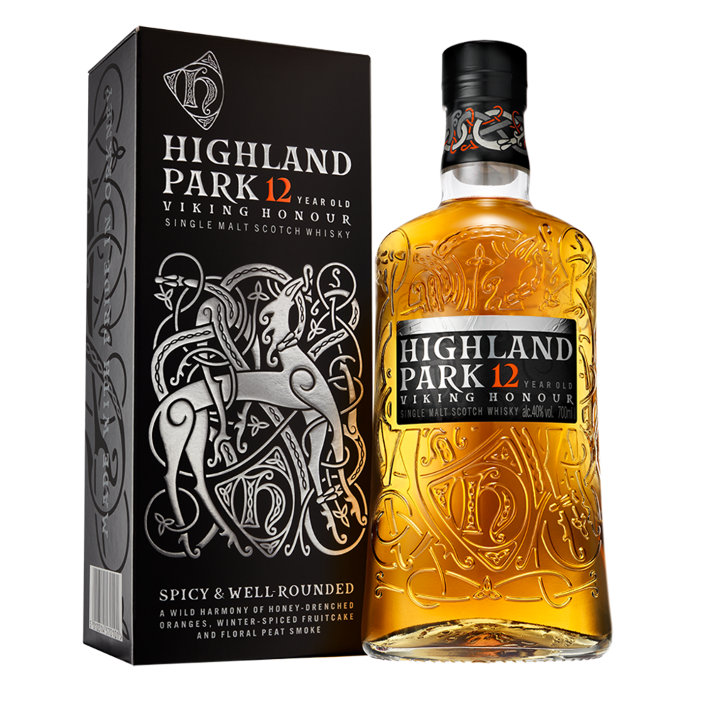 A bottle of Highland Park 12 Year Old Viking Honour Single Malt Scotch Whisky stands beside its black box, adorned with silver Viking-inspired artwork and bold text, representing its Orkney Islands heritage.