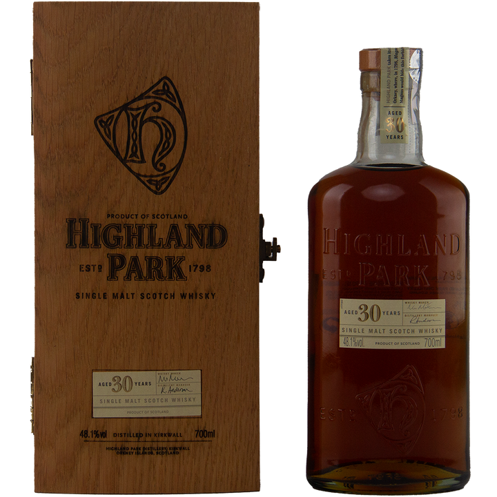 A bottle of Highland Park 30 Year Old Single Malt Whisky stands next to its wooden box, both featuring engraved and printed details—an exceptional collector’s item for whisky enthusiasts.