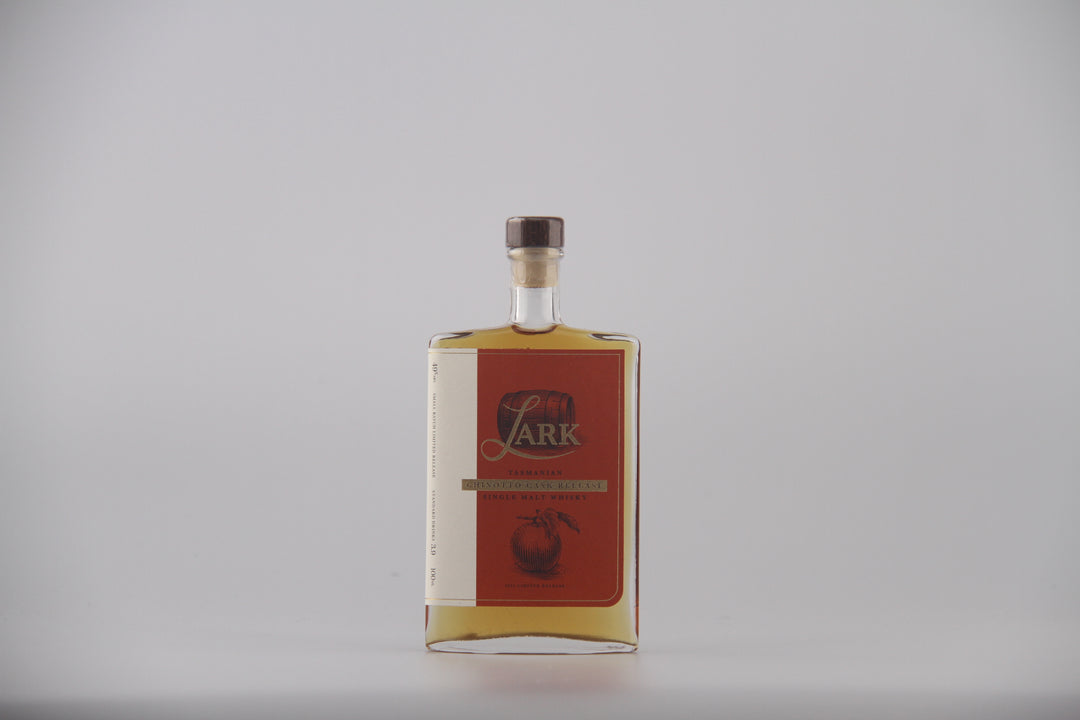 A bottle of Lark brand liquor with a red label and gold lettering, set against a plain light gray background.