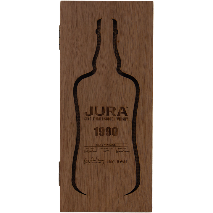 A wooden box featuring the silhouette of a whisky bottle, engraved with Jura 1990 30 Year Old Single Malt Whisky—a collectible Scotch with detailed text and signature accents.