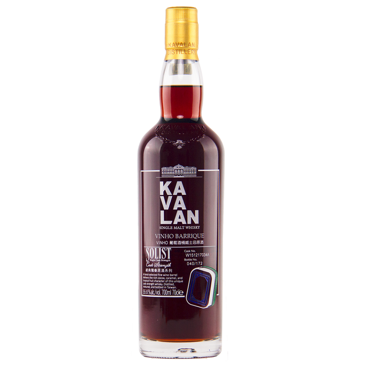 A bottle of Kavalan 2015 Vinho Barrique Cask No. W151217034A Taiwanese whisky with dark amber liquid, a gold cap, and a detailed label displaying white and gold English and Chinese text.
