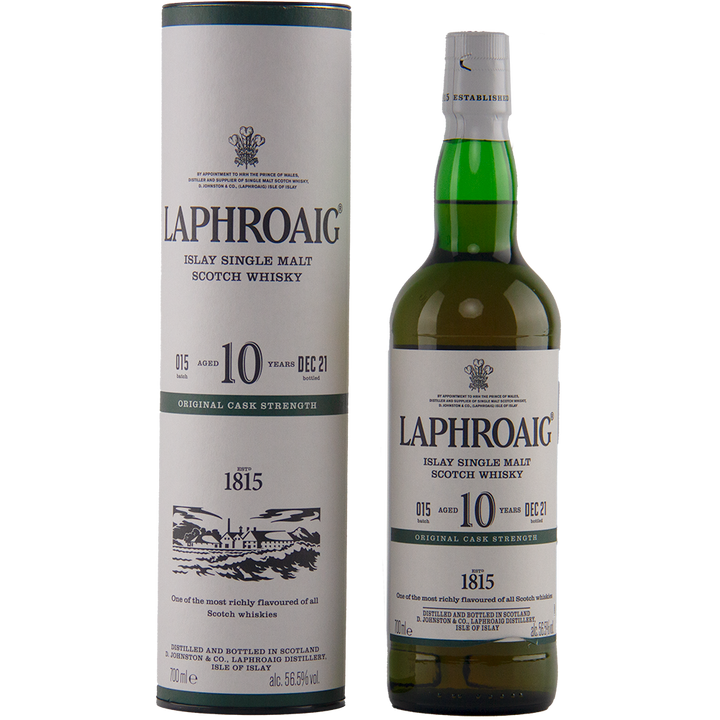 A bottle of Laphroaig 10 Year Old Cask Strength Batch 15 stands beside its cylindrical packaging, both featuring the brand name, age statement, and distillery details in classic black and green text.