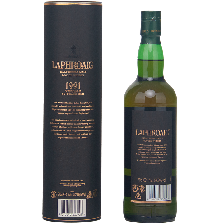 A bottle of Laphroaig 1991 Vintage 23 Year Old Single Malt Whisky stands by its cylindrical box, both adorned with gold text on a dark background. This collector’s edition is bottled at cask strength—52.6% ABV.