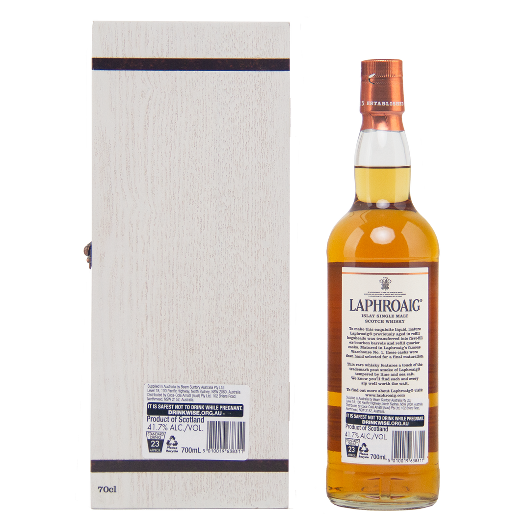 A bottle of Laphroaig 27 Year Old Single Malt Whisky with a copper cap stands beside its tall, light wooden box, both shown from the back to highlight their investment-grade labels and detailed packaging.