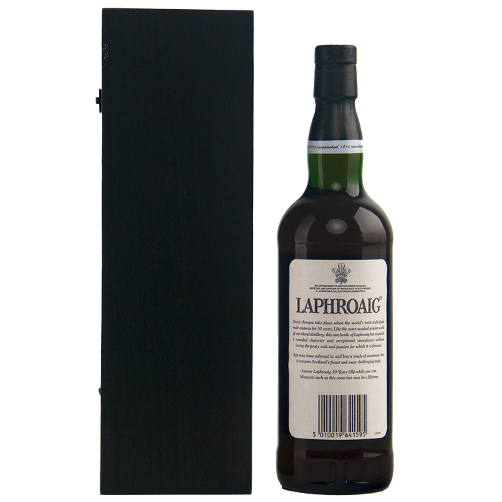 A bottle of Laphroaig 30 Year Old Limited Edition Single Malt Whisky stands beside a tall black box against a white background, featuring a white label and green cap—an exceptional, rare collectible for whisky enthusiasts.