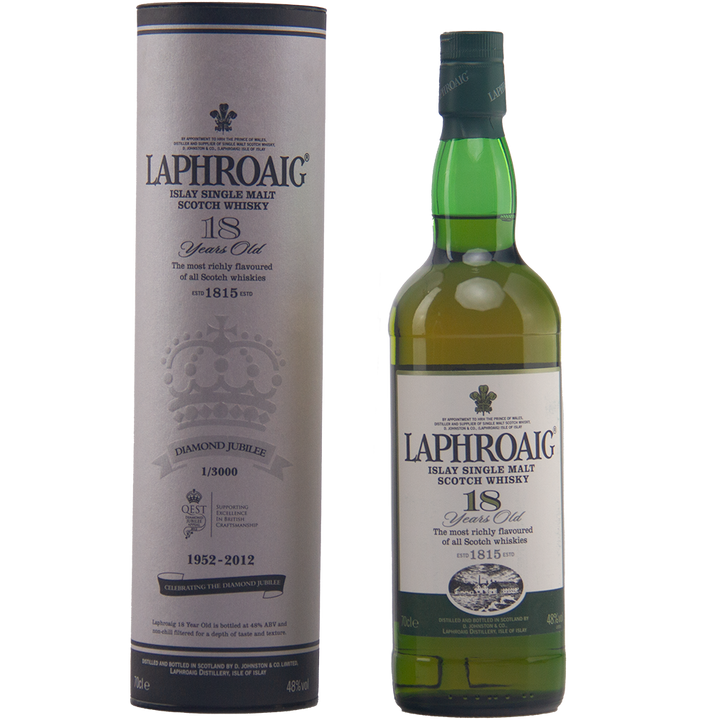 A bottle of Laphroaig Diamond Jubilee 18 Year Old Limited Edition stands by its cylindrical box, both with commemorative labels marking 1952-2012—a rare collectible whisky for discerning enthusiasts.
