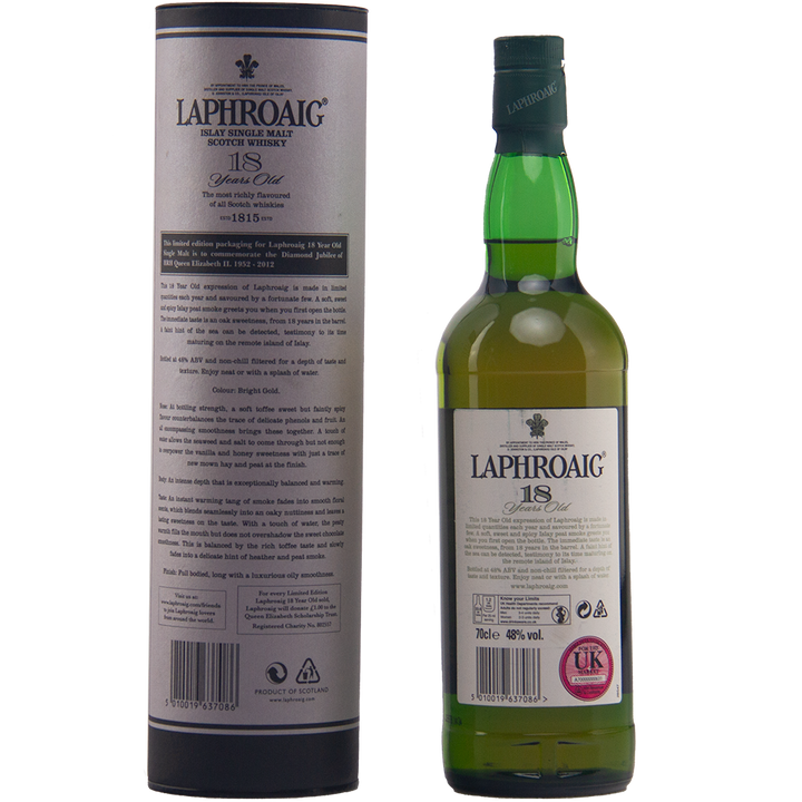 A green bottle of Laphroaig Diamond Jubilee 18 Year Old Limited Edition stands beside its matching cylindrical box, both featuring white, black, and gold branding—a rare collectible whisky treasured by enthusiasts.