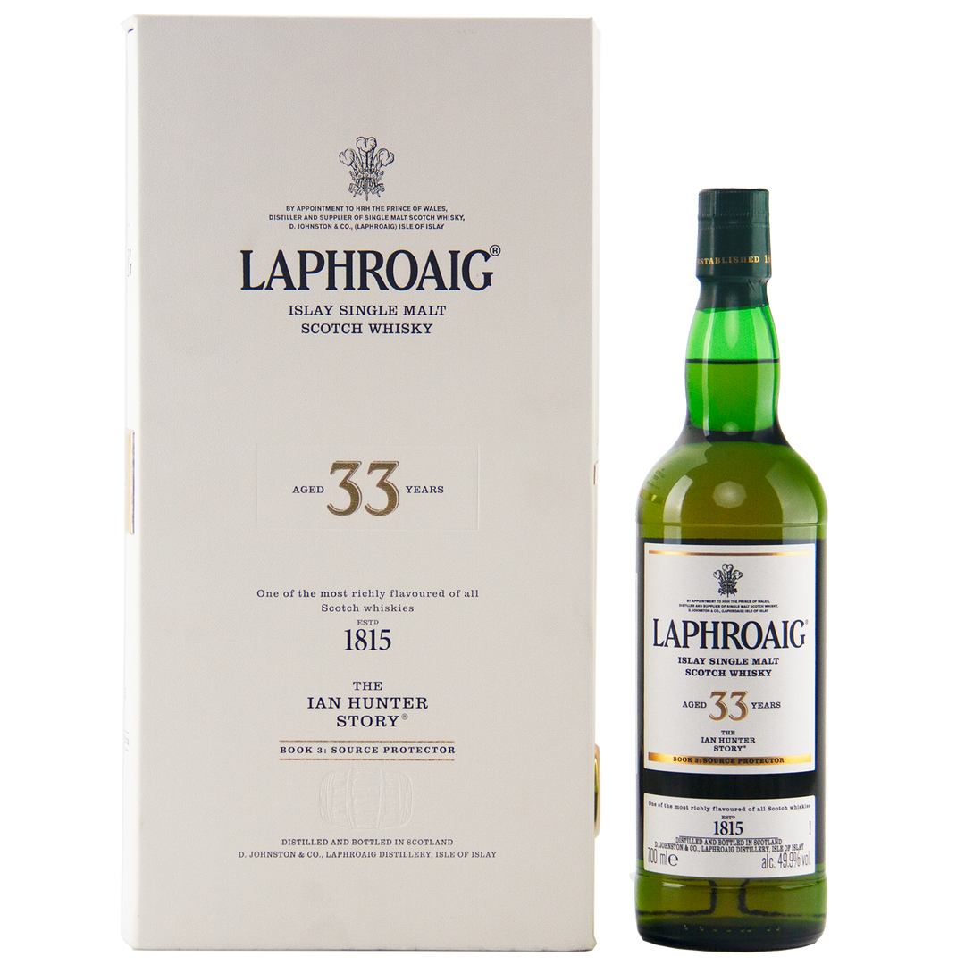 A bottle of Laphroaig Ian Hunter Series Book 3 33 Year Old Single Malt Whisky stands beside its white box, both featuring black and gold text that highlights the product’s details and branding.