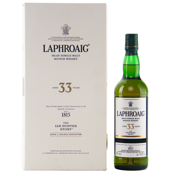 A bottle of Laphroaig Ian Hunter Series Book 3 33 Year Old Single Malt Whisky stands beside its white box, both featuring black and gold text that highlights the product’s details and branding.
