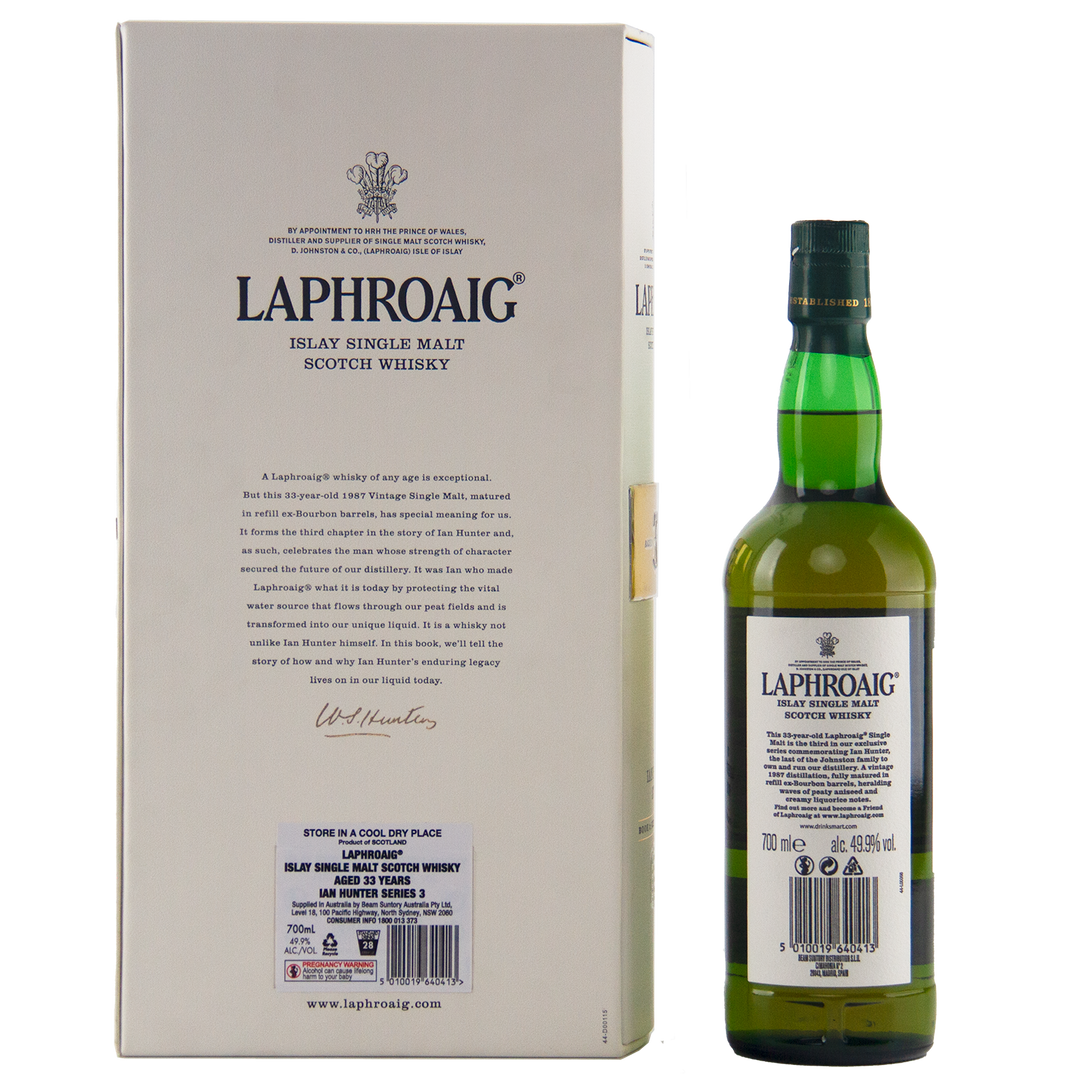 A green bottle of Laphroaig Ian Hunter Series Book 3 33 Year Old Single Malt Whisky stands beside its cream box, both with bold black text and the iconic logo—a prized addition for any whisky collector.