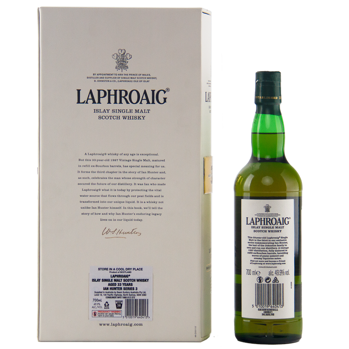 A green bottle of Laphroaig Ian Hunter Series Book 3 33 Year Old Single Malt Whisky stands beside its cream box, both with bold black text and the iconic logo—a prized addition for any whisky collector.
