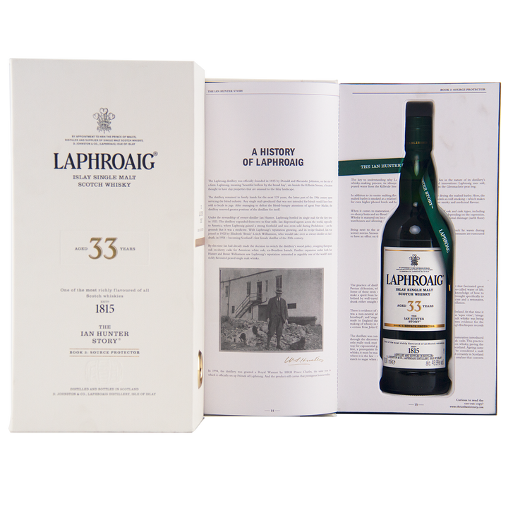 A box and open booklet showcase the Laphroaig Ian Hunter Series Book 3 33 Year Old Single Malt Whisky, featuring brand history text and a black-and-white portrait—an ideal gift for collectible whisky enthusiasts.