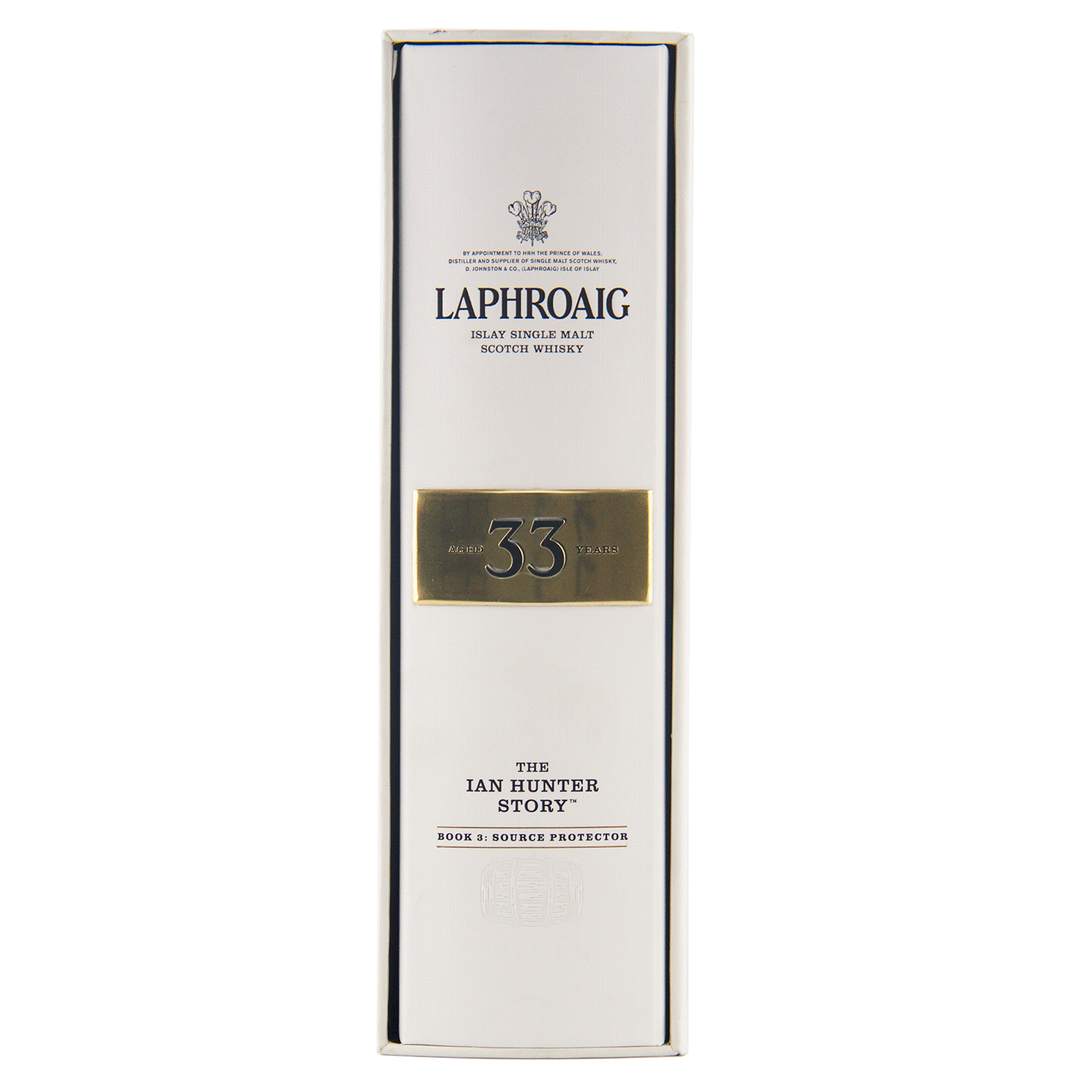 The Laphroaig Ian Hunter Series Book 3 33 Year Old Single Malt Whisky comes in a white box with “The Ian Hunter Story” and “Book 3: Source Protector” in bold black and gold lettering, making it a collectible whisky.