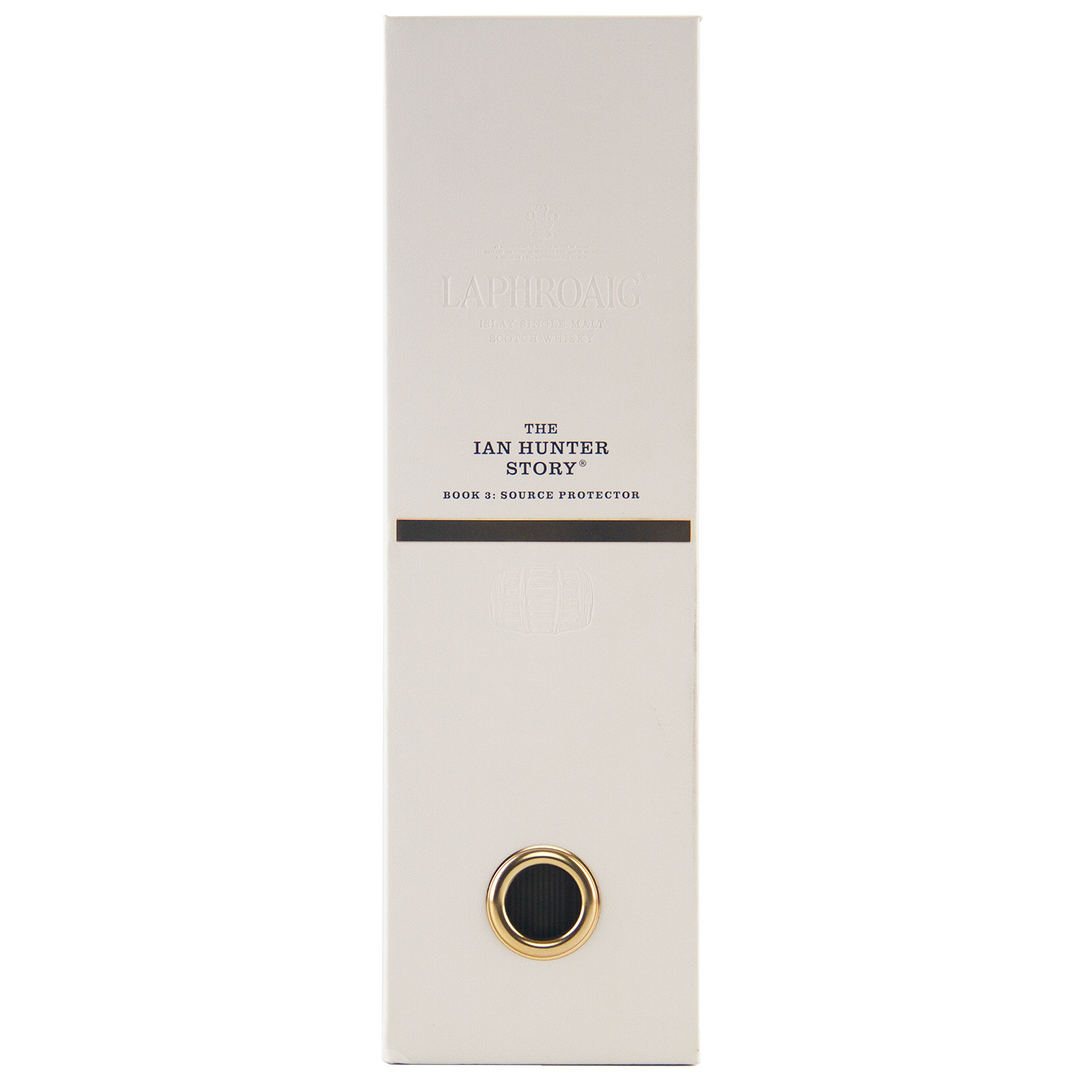 A tall, rectangular white box with gold and black accents displays “Laphroaig Ian Hunter Series Book 3 33 Year Old Single Malt Whisky” on the front. A circular gold-bordered detail is near the bottom of this collectible whisky packaging.