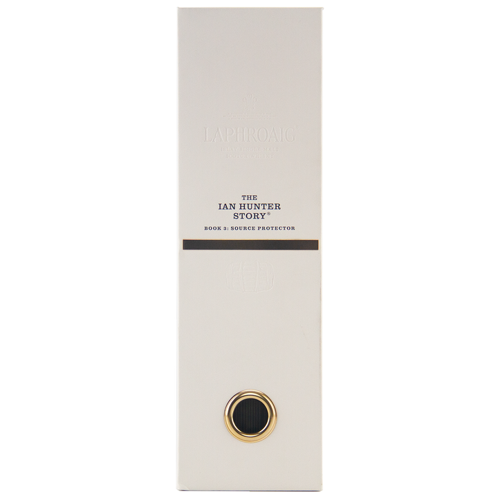 A tall, rectangular white box with gold and black accents displays “Laphroaig Ian Hunter Series Book 3 33 Year Old Single Malt Whisky” on the front. A circular gold-bordered detail is near the bottom of this collectible whisky packaging.