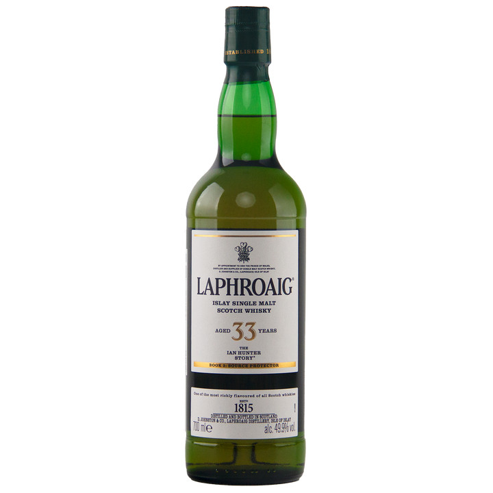 A green bottle of Laphroaig Ian Hunter Series Book 3 33 Year Old Single Malt Whisky, with a white label and gold trim, stands upright on a white background—a true collectible for whisky enthusiasts.