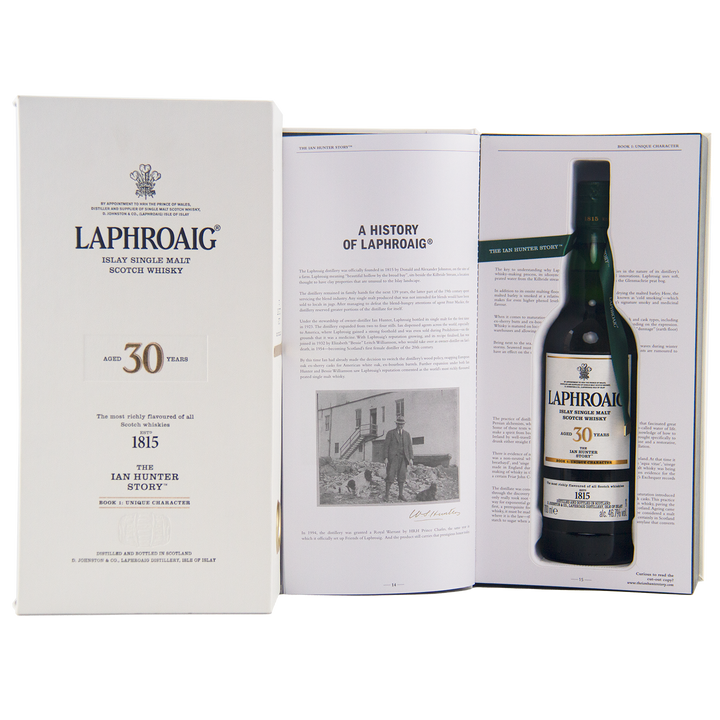 A Laphroaig Ian Hunter Story Book 1 30 Year Old Single Malt Whisky gift box opens to reveal the collector’s bottle and a booklet titled "A History of Laphroaig," featuring a black-and-white photo that celebrates Ian Hunter’s legacy.