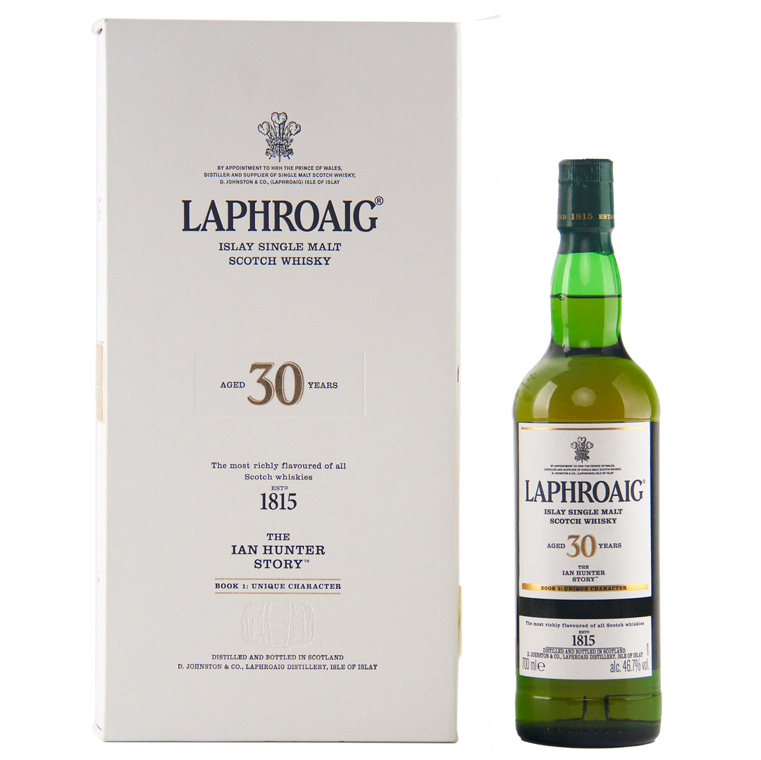 A bottle of Laphroaig Ian Hunter Story Book 1 30 Year Old Single Malt Whisky stands next to its cream presentation box, both proudly showcasing the brand and celebrating this special Islay whisky’s rare age and edition.