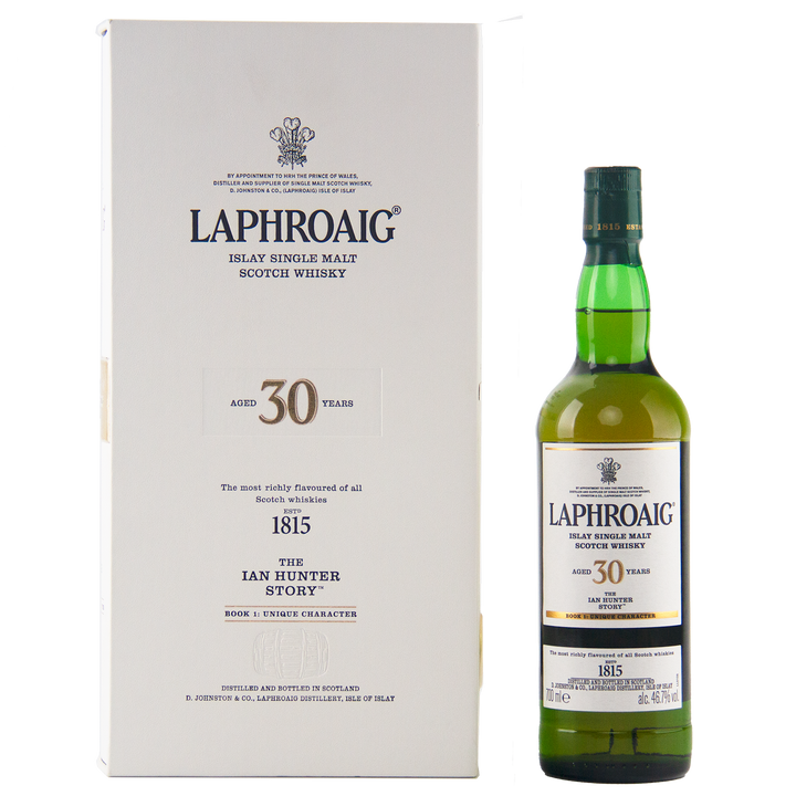 A bottle of Laphroaig Ian Hunter Story Book 1 30 Year Old Single Malt Whisky stands next to its cream presentation box, both proudly showcasing the brand and celebrating this special Islay whisky’s rare age and edition.