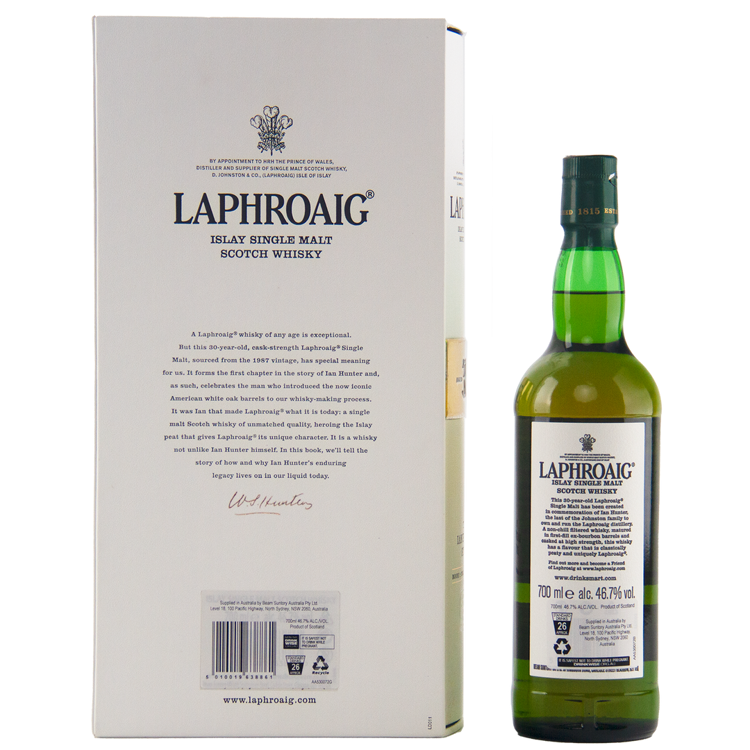 A green bottle of Laphroaig Ian Hunter Story Book 1 30 Year Old Single Malt Whisky stands beside its white box, both displaying the brand and details of this exclusive collector’s edition.