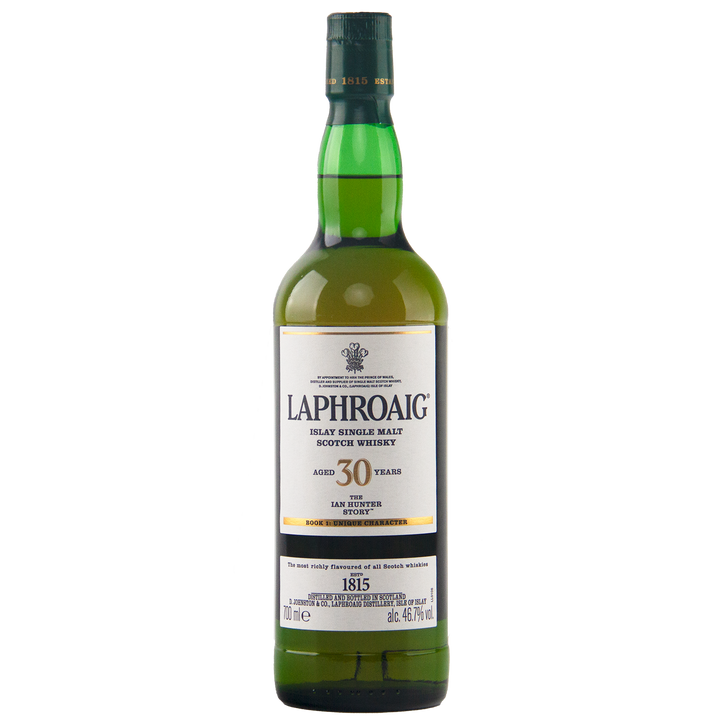 A green glass bottle of Laphroaig Ian Hunter Story Book 1 30 Year Old Single Malt Whisky, with a white and gold label and green cap, stands upright on a white background.