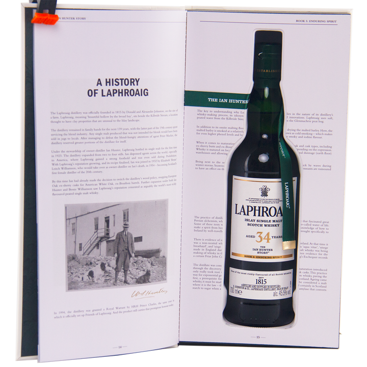 An open book titled "A History of Laphroaig" with a black-and-white photo reveals a cutout on the right holding a bottle of Laphroaig Ian Hunter Story Book 5 34 Year Old Single Malt Whisky.