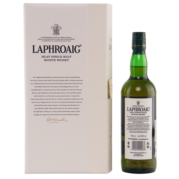 A bottle of Laphroaig Ian Hunter Story Book 5 34 Year Old Single Malt Whisky is displayed beside its white box, featuring detailed product info and black text. The green bottle has a classic white label.