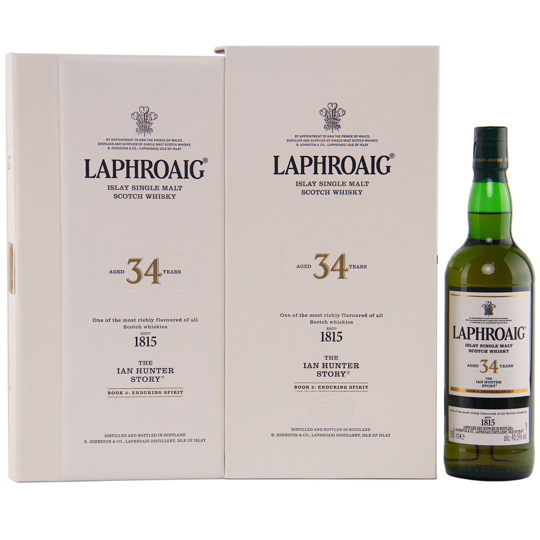 A bottle of Laphroaig Ian Hunter Story Book 5 34 Year Old Single Malt Whisky stands beside its white box, both featuring black and gold accents that highlight this refined Islay release with elegant decorative details.