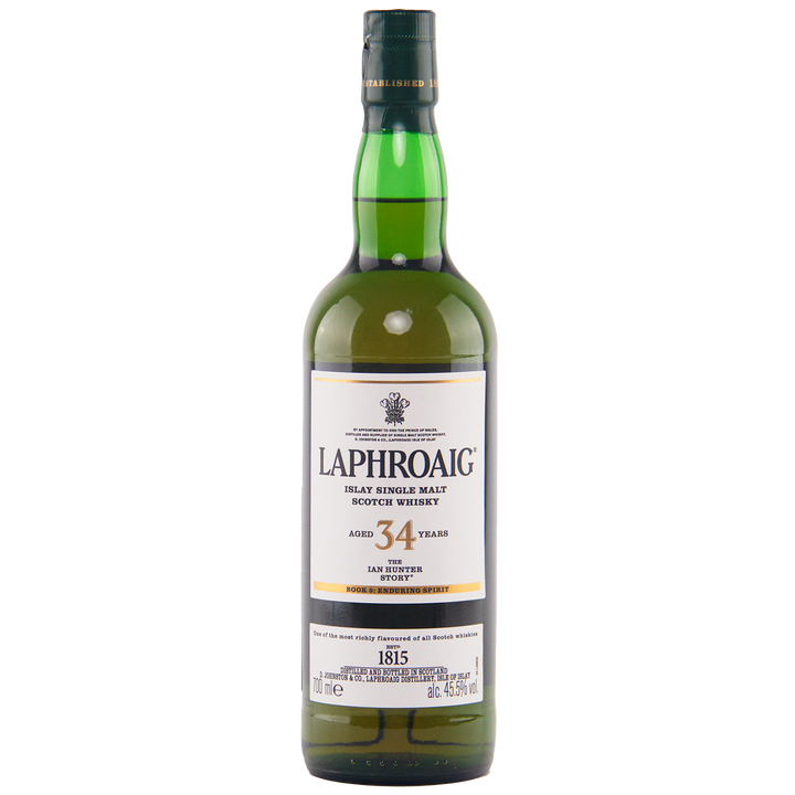 A bottle of Laphroaig Ian Hunter Story Book 5 34 Year Old Single Malt Whisky, an outstanding Islay single malt. It comes in a green bottle with a white label featuring black and gold text, topped by a green cap.