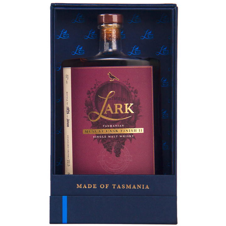 A bottle of Lark Muscat Cask Finish II Single Malt Whisky with a red and gold label stands upright in a blue gift box marked "MADE OF TASMANIA" at the bottom.