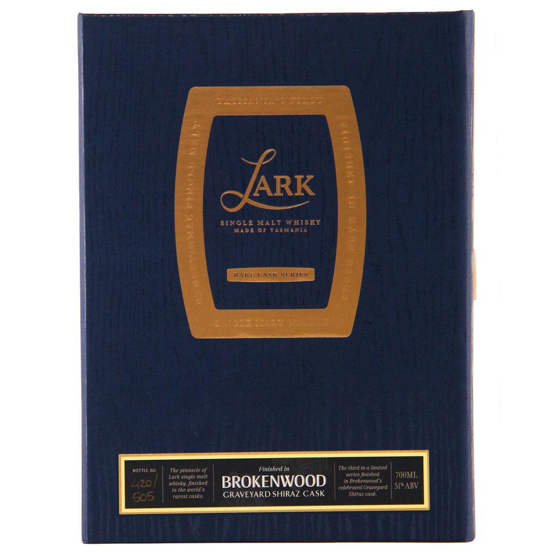 A dark blue box with gold text and accents features a barrel outline framing Lark Brokenwood Graveyard Shiraz Rare Cask Single Malt Whisky, with a gold "Rare Cask Series" label at the bottom.