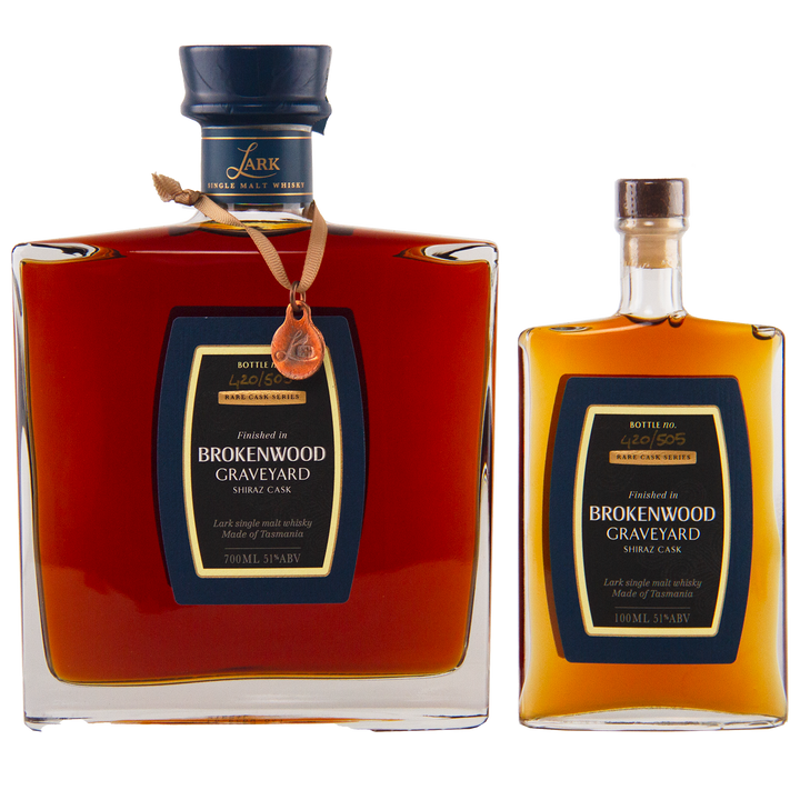 Two bottles of Lark Brokenwood Graveyard Shiraz Rare Cask Single Malt Whisky—one large with a wax seal and ribbon, and one small—both with dark labels and gold accents.
