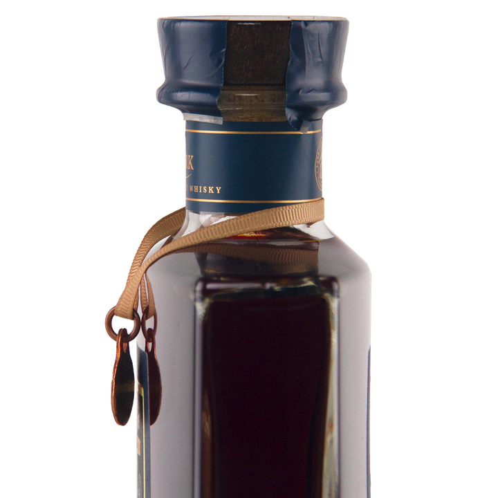 A close-up of the Lark Brokenwood Graveyard Shiraz Rare Cask Single Malt Whisky, featuring a square glass bottle with a blue wax seal, gold ribbon, and dark amber Tasmanian whisky inside against a minimal white background.