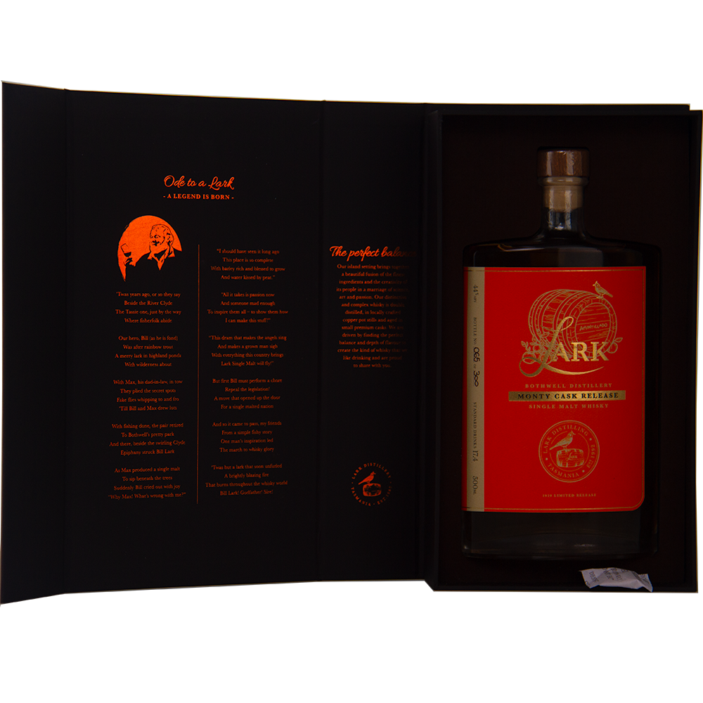 A large bottle of Lark Monty Cask Release Single Malt Whisky, with a red and gold label, is displayed in an open black box. The inside cover has orange text and a small illustration describing this limited edition whisky.
