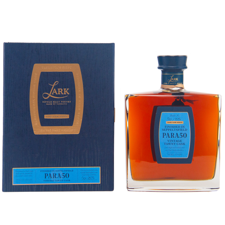 A rectangular dark blue box with gold and blue label sits beside a square bottle of amber Lark Seppeltsfield Para 50 II Rare Cask Single Malt Whisky, a limited edition Australian whisky with a matching blue cap and elegant blue-gold label.