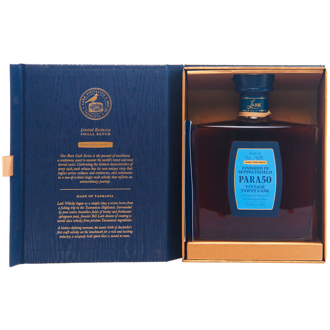 A square bottle of Lark Seppeltsfield Para 50 II Rare Cask Single Malt Whisky with a blue label is displayed in an open blue and gold box, gold text details this limited edition on the left, while the bottle rests securely on the right.