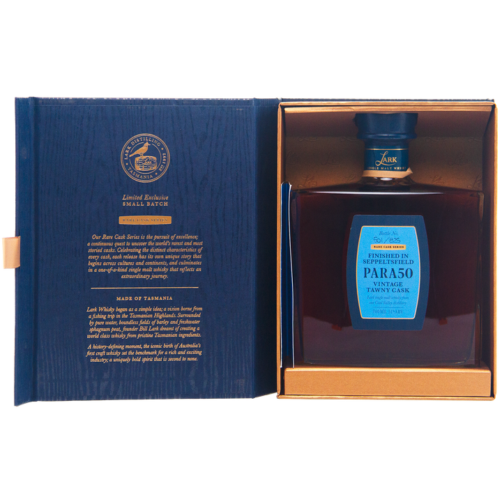 A square bottle of Lark Seppeltsfield Para 50 II Rare Cask Single Malt Whisky with a blue label is displayed in an open blue and gold box, gold text details this limited edition on the left, while the bottle rests securely on the right.
