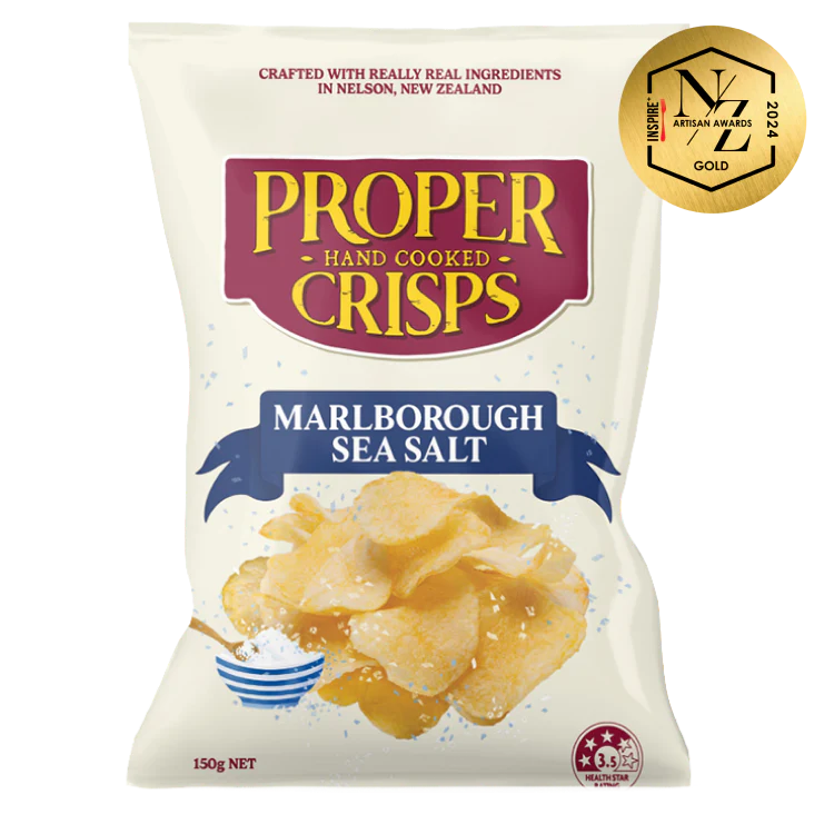 A white bag of Proper Crisps Marlborough Sea Salt gluten-free crisps features crunchy chips, a salt bowl with spoon, and an NZ Artisan Awards 2022 gold sticker in the top right corner.