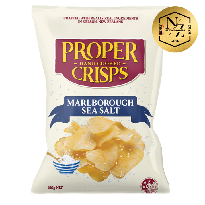 A white bag of Proper Crisps Marlborough Sea Salt gluten-free crisps features crunchy chips, a salt bowl with spoon, and an NZ Artisan Awards 2022 gold sticker in the top right corner.
