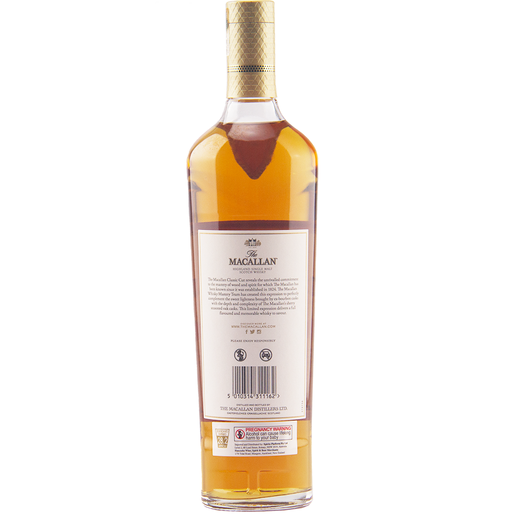 A bottle of The Macallan Classic Cut 2021 Release Single Malt Scotch Whisky viewed from the back shows a white label, gold foil cap seal, and amber cask strength liquid inside its clear glass bottle.