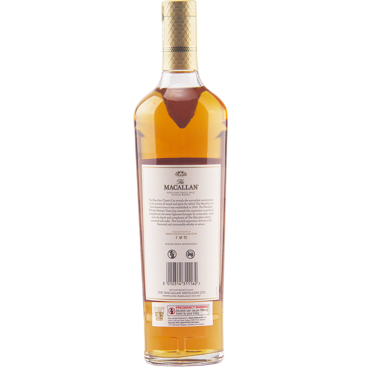 A bottle of The Macallan Classic Cut 2021 Release Single Malt Scotch Whisky viewed from the back shows a white label, gold foil cap seal, and amber cask strength liquid inside its clear glass bottle.