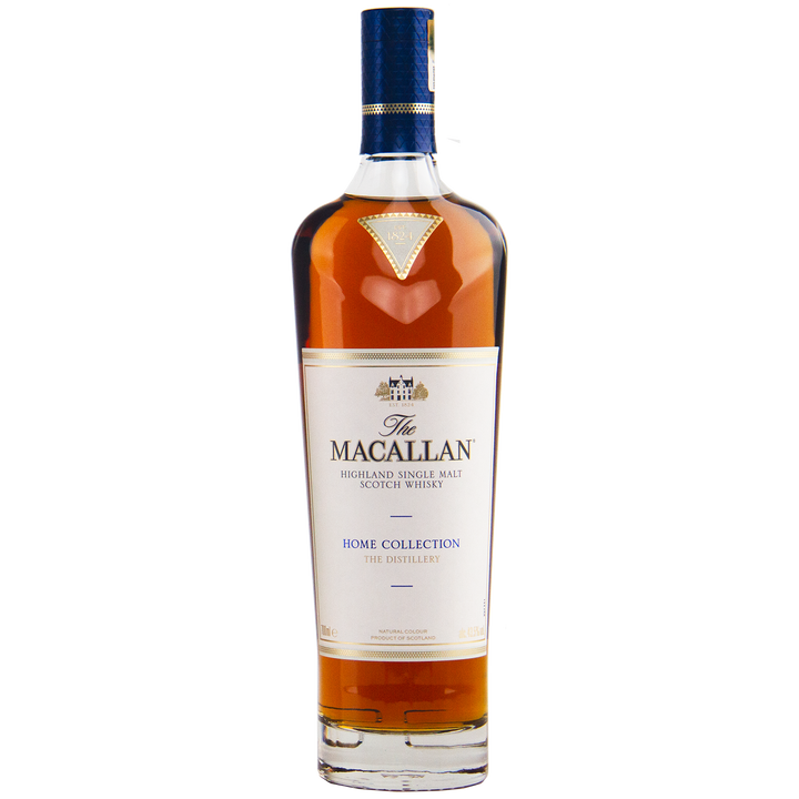 A collectible, The Macallan Home Collection The Distillery Single Malt Scotch Whisky features a white label with gold and blue accents, showcasing its rich amber liquid inside.