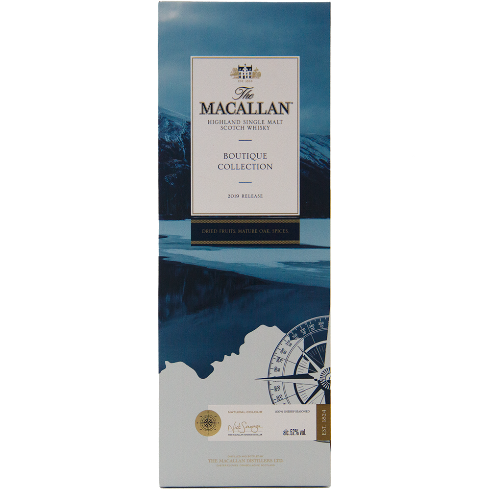 A rectangular box for The Macallan Boutique Collection 2019 Release Single Malt Whisky, adorned with blue and white mountain imagery, a whisky compass design, and gold and black text—emphasizing its travel retail exclusivity.