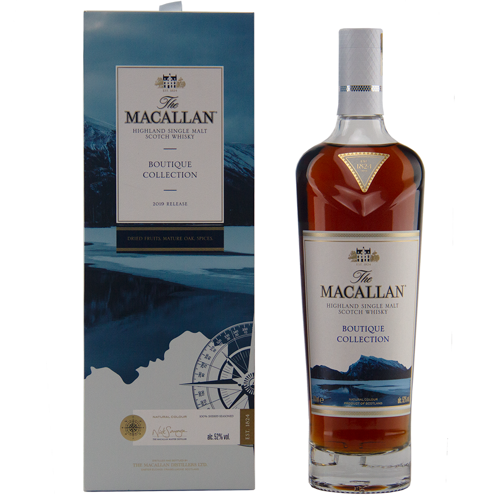 A bottle of The Macallan Boutique Collection 2019 Release Single Malt Whisky stands by its blue and white box, featuring mountain and lake artwork that emphasizes its travel retail exclusivity.