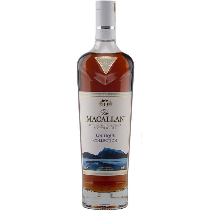 The Macallan Boutique Collection 2019 Release Single Malt Whisky features amber liquid and a label with blue mountains and gold accents, crafted exclusively for travel retail.
